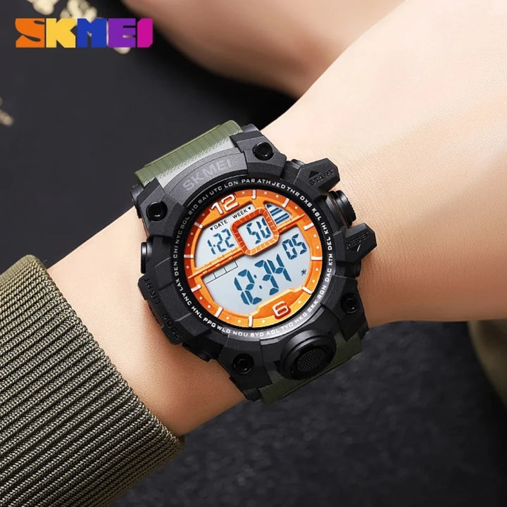 Digital watch with green strap on wrist, brand 'SKMEI' visible